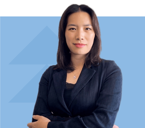 Claudia Pun in a dark blazer, smiling, with her arms crossed