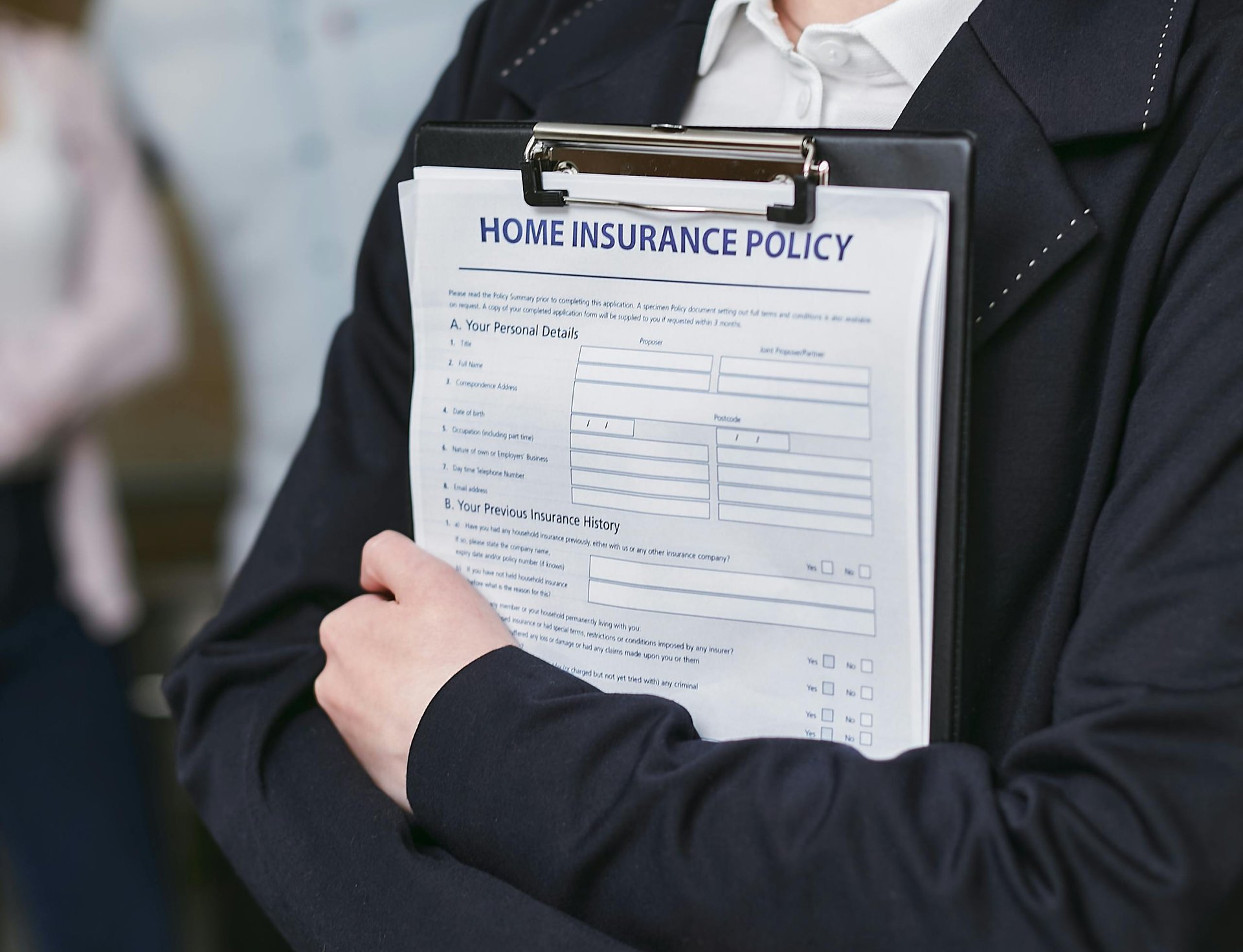 Person holding an insurance policy document on a clipboard representing aged care provider insurance compliance requirements