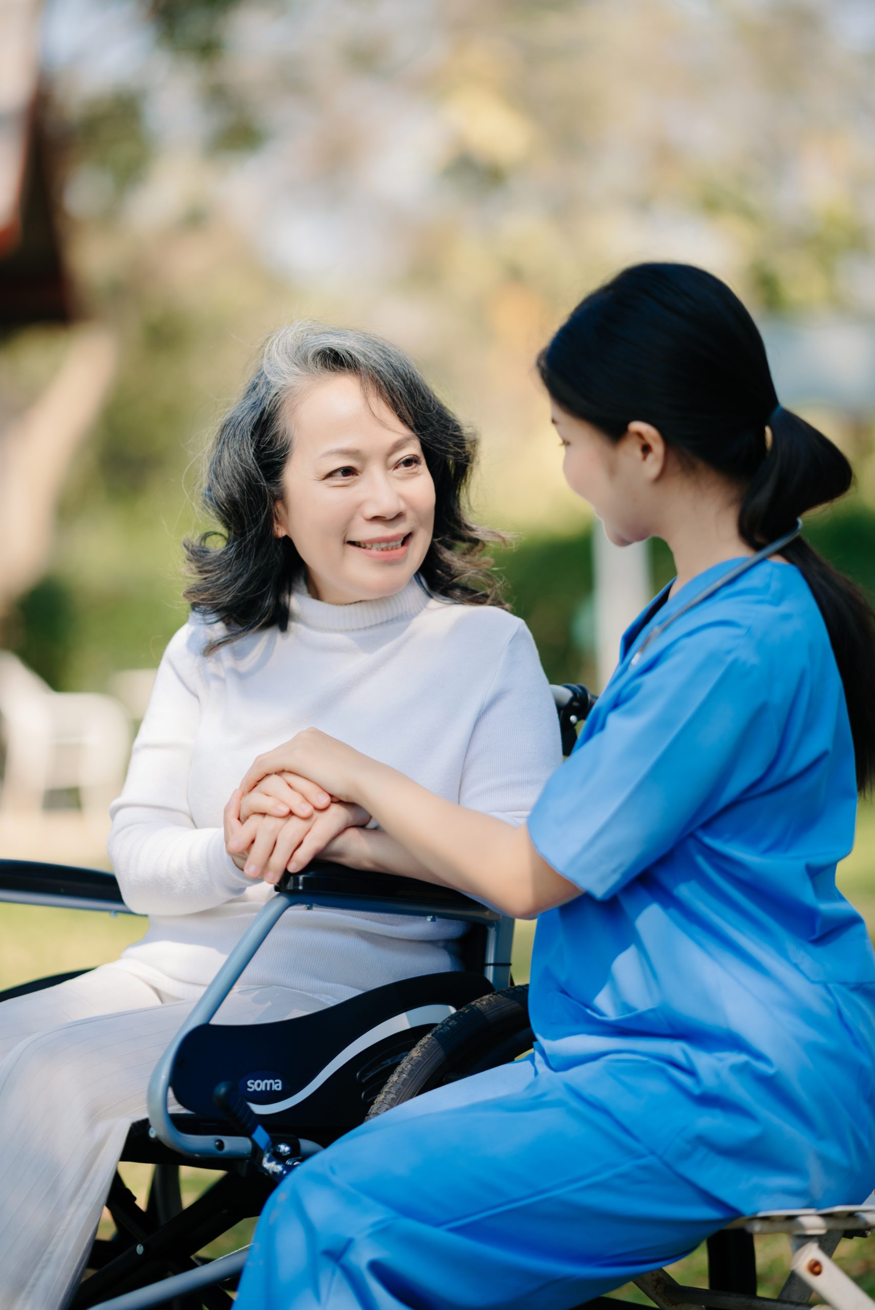 Elderly Asian senior woman on wheelchair with quality aged care support