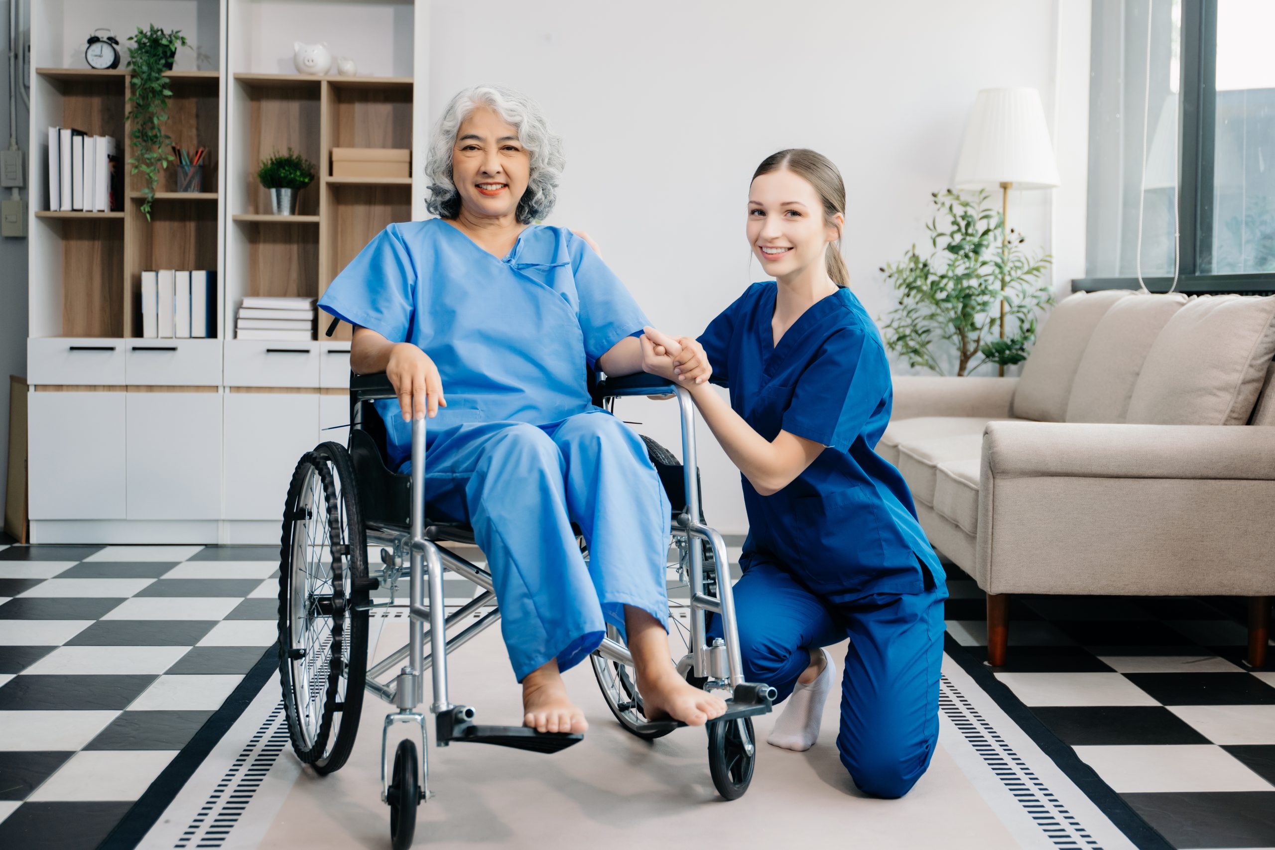 Nurse helping elderly woman walk in room
