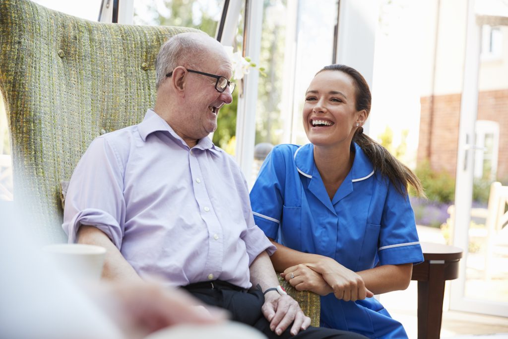 Senior man receiving expert aged care consulting and advisory services from professional nurse consultant